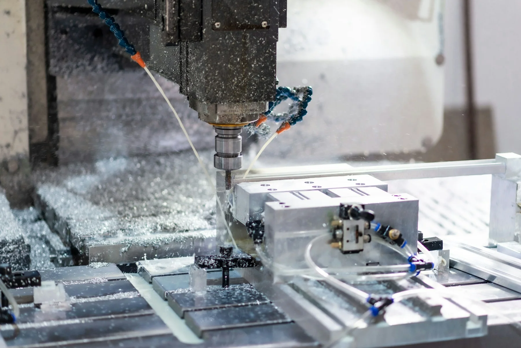 An aluminum component clamped in a dedicated CNC milling fixture.