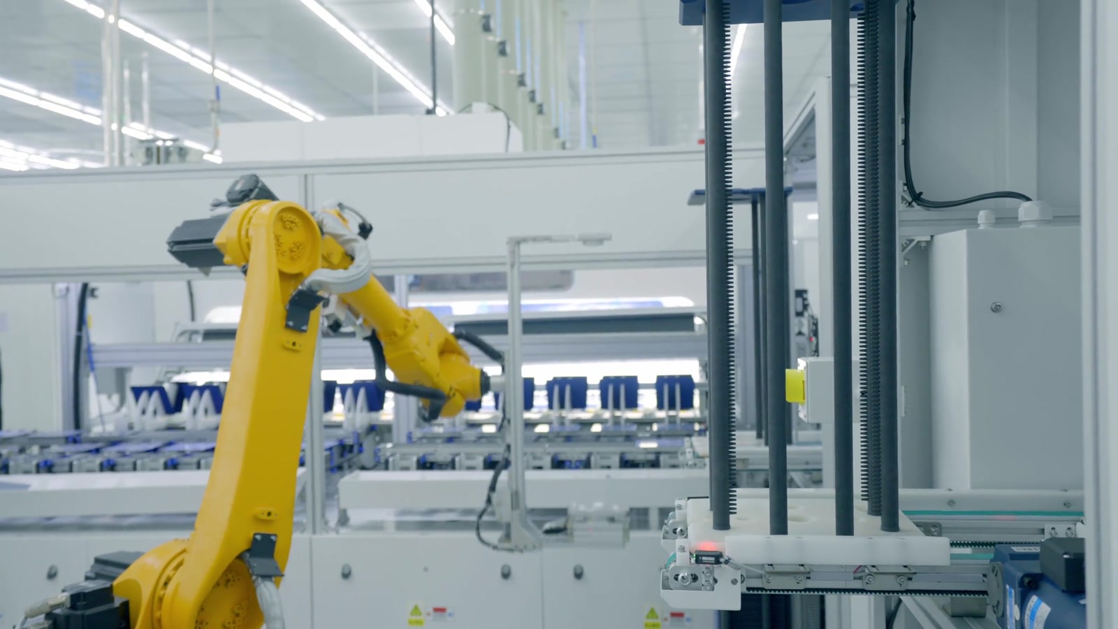 Robotic arm working inside an automated manufacturing cell.