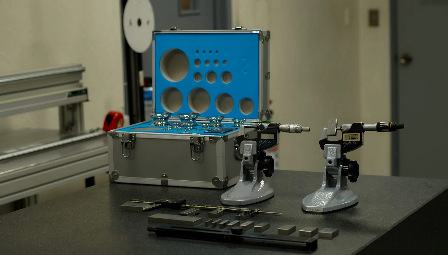 Measurement instruments and reference gauges arranged on a metrology bench.