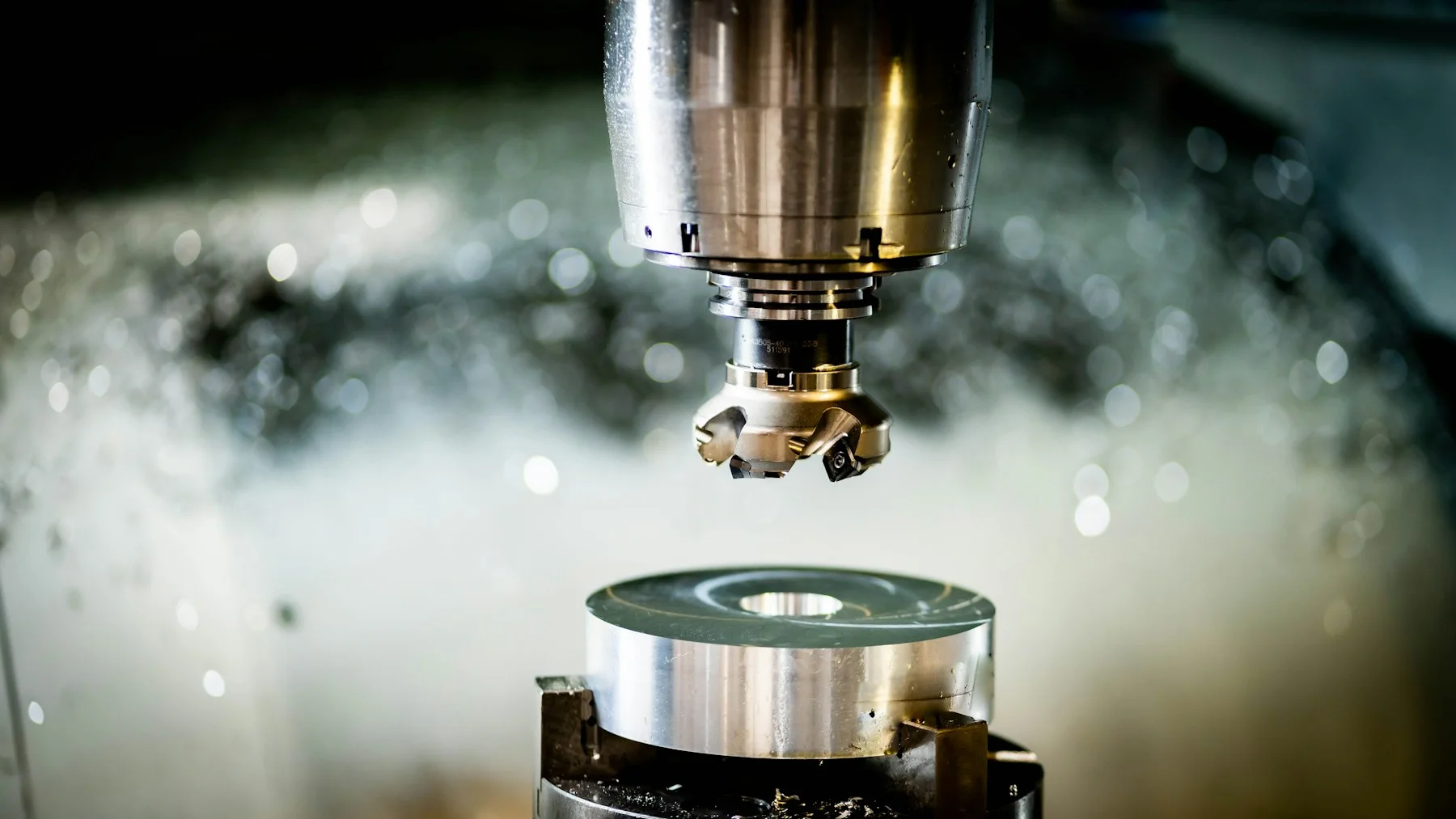 A face mill positioned above a clamped metal component.