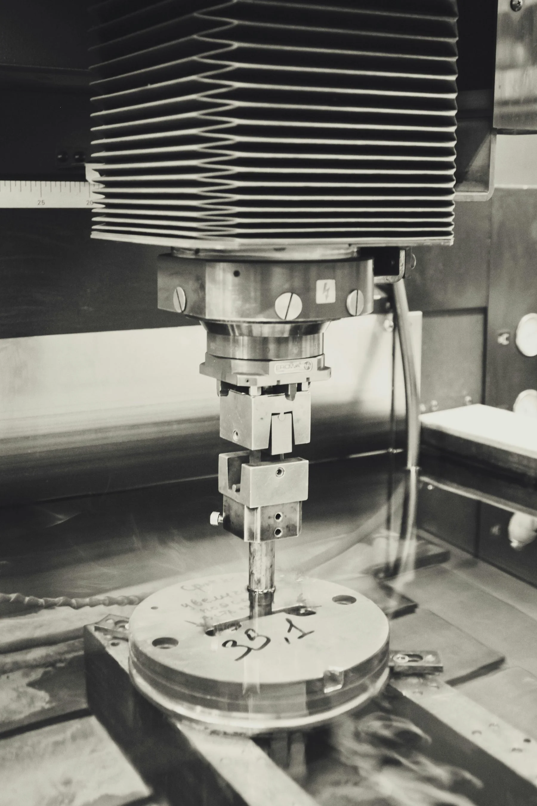 Machining spindle, worktable, and coolant delivery inside the enclosure.