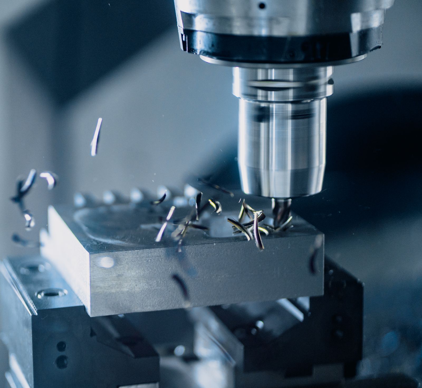 Close-up of a cutter and the machined surface of a metal part.