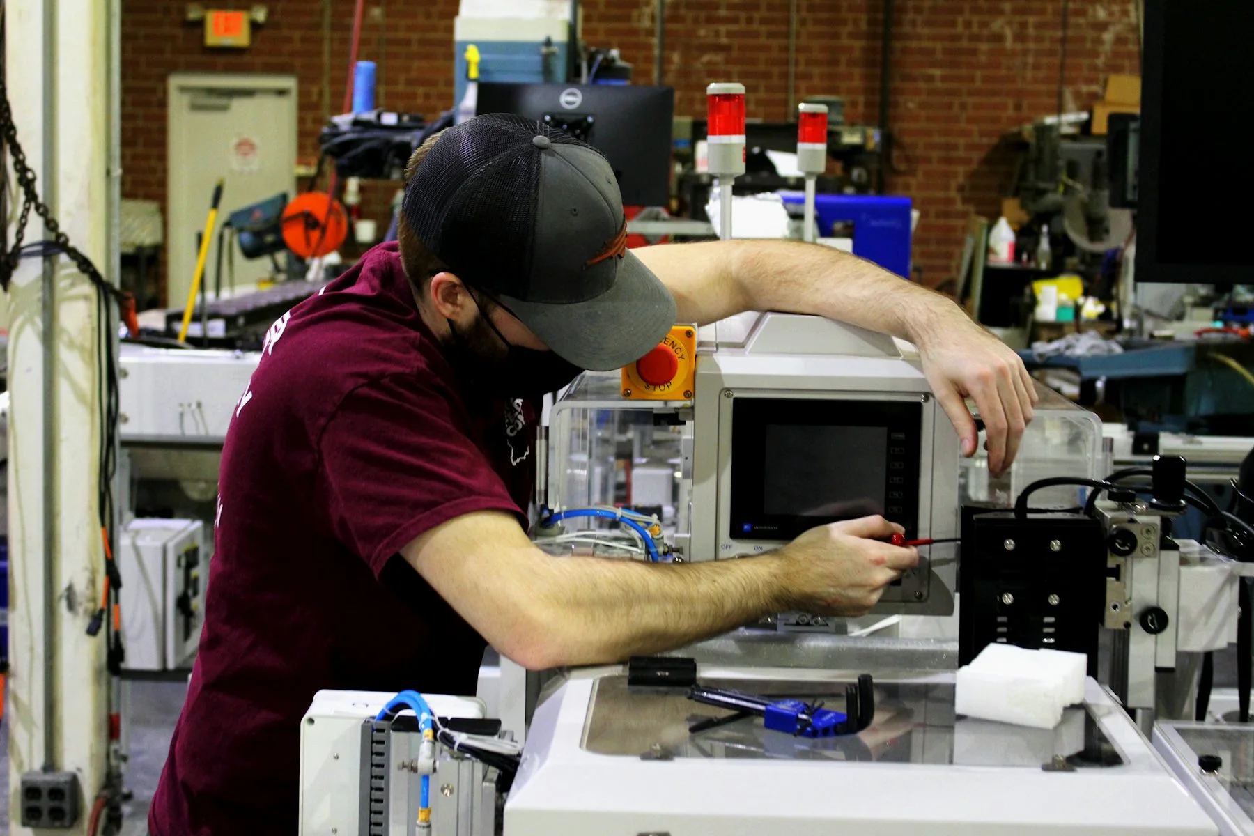 A technician setting up equipment at a workshop station.